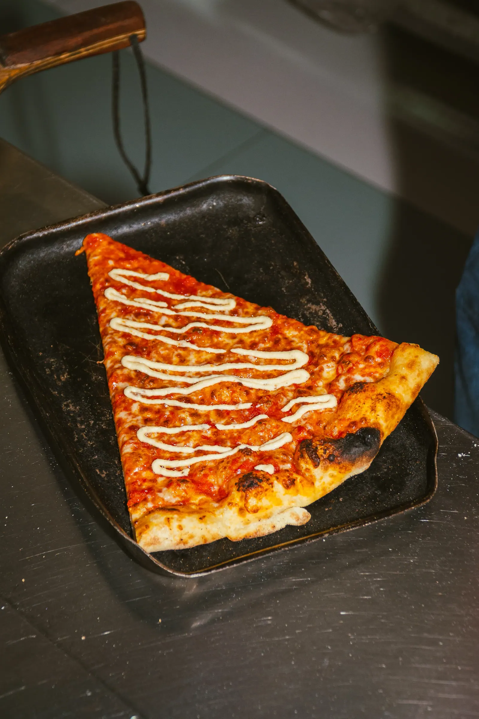 Close-up of a crisp New York pizza at Frankie's Cork